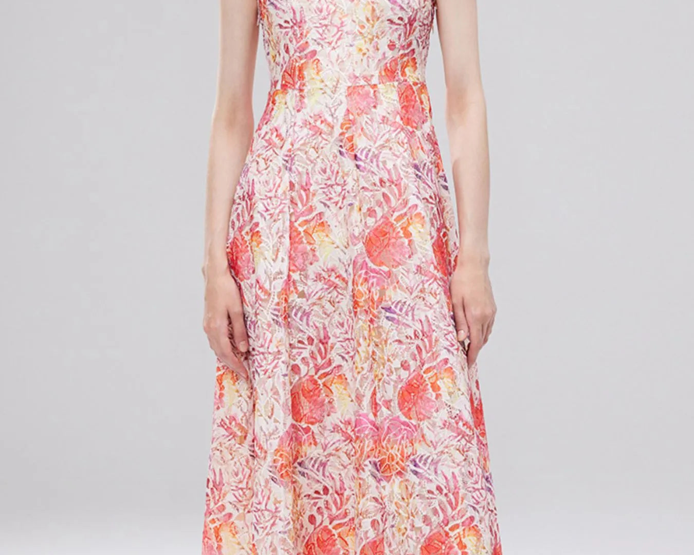 NEWYORKLISTED STYLE COLLECTION: Woman wearing a floral dress on a plain background