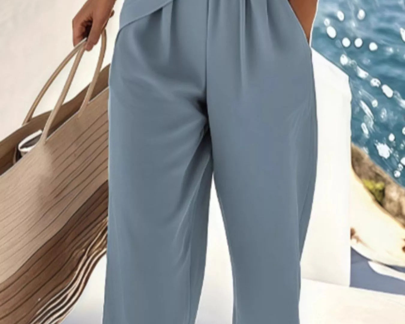 NEWYORKLISTED STYLE COLLECTION: Person wearing a light blue jumpsuit by a waterfront.