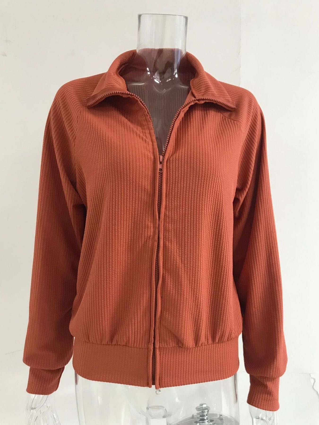 NEWYORKLISTED STYLE COLLECTION: Brown ribbed knit jacket on a mannequin against a white background