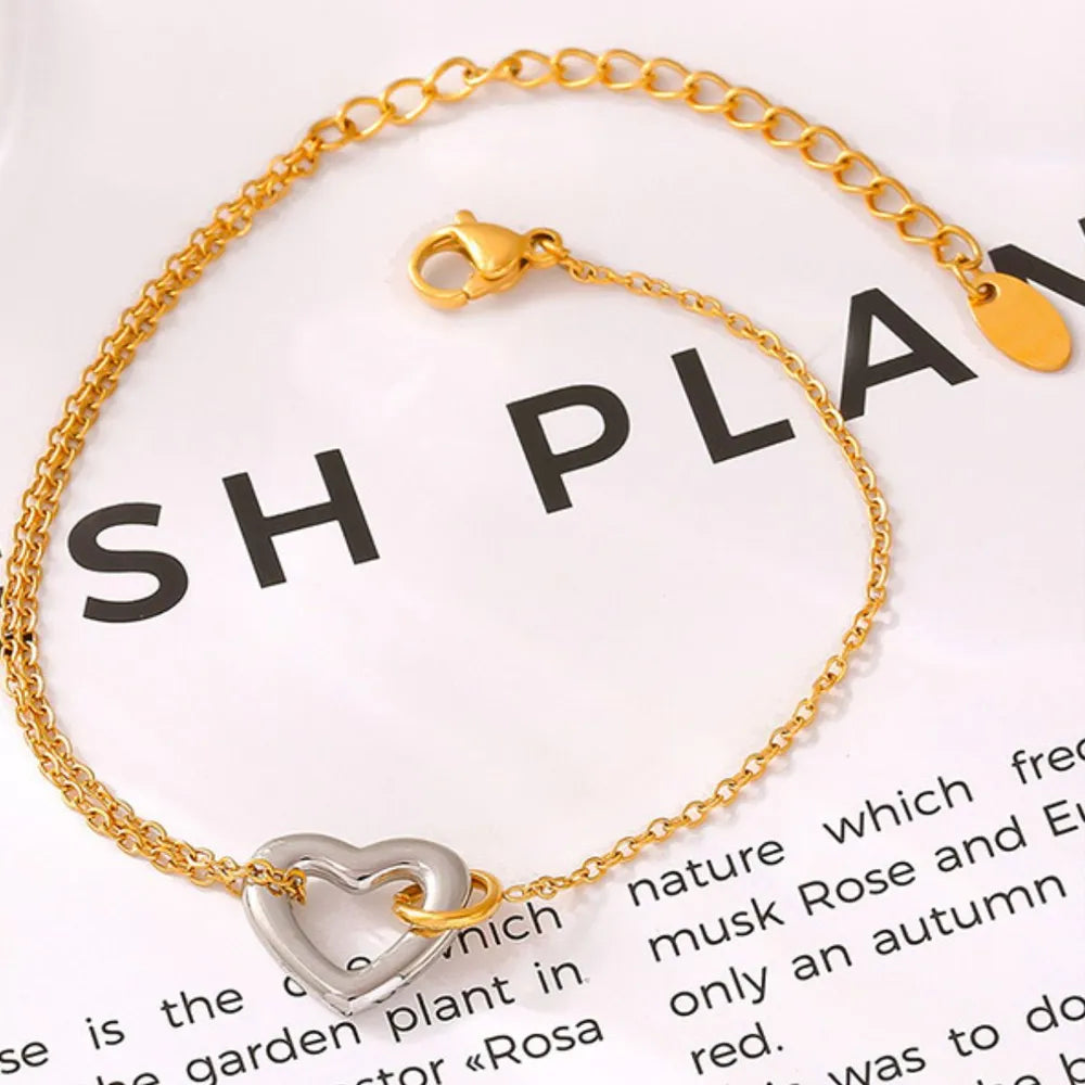 NEWYORKLISTED Valentine's Day Specials: Gold bracelet with a heart-shaped charm on a white background