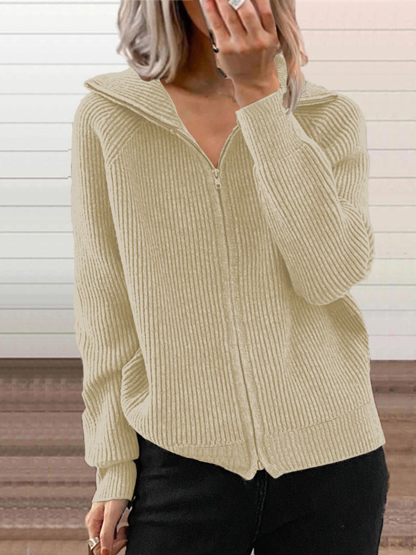 NEWYORKLISTED STYLE COLLECTION: Person wearing a beige ribbed zip-up sweater against a neutral background