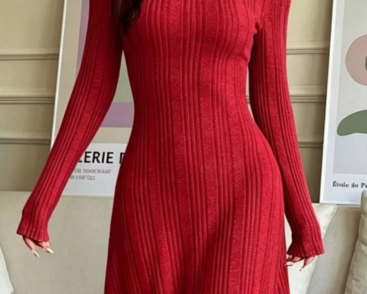 NEWYORKLISTED STYLE COLLECTION: A woman wearing a long-sleeve, ribbed knit midi dress in a deep red color, standing in a living room setting.