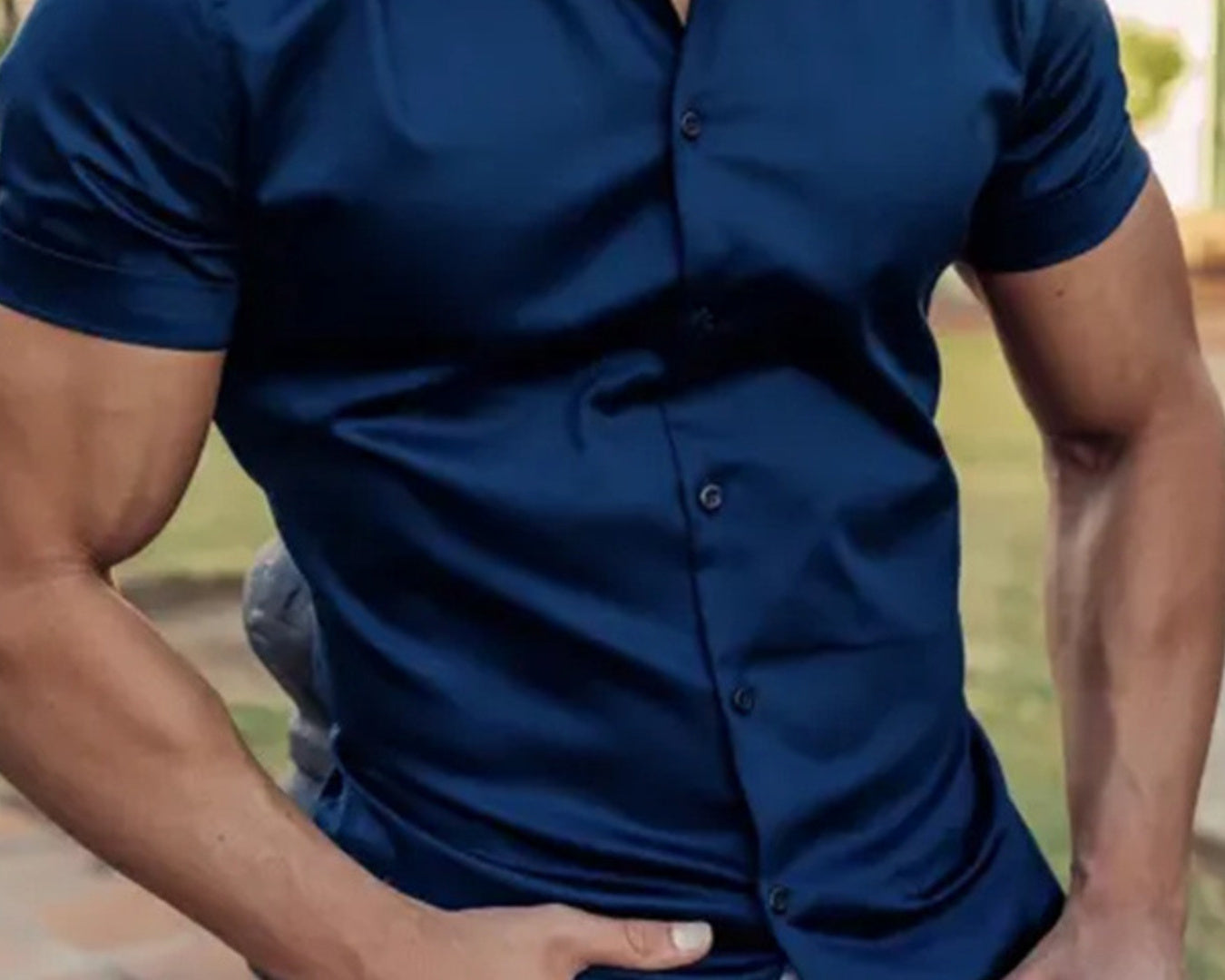 NEWYORKLISTED ATLAS MEN's COLLECTION: Man wearing a navy blue button-up shirt with a blurred outdoor background