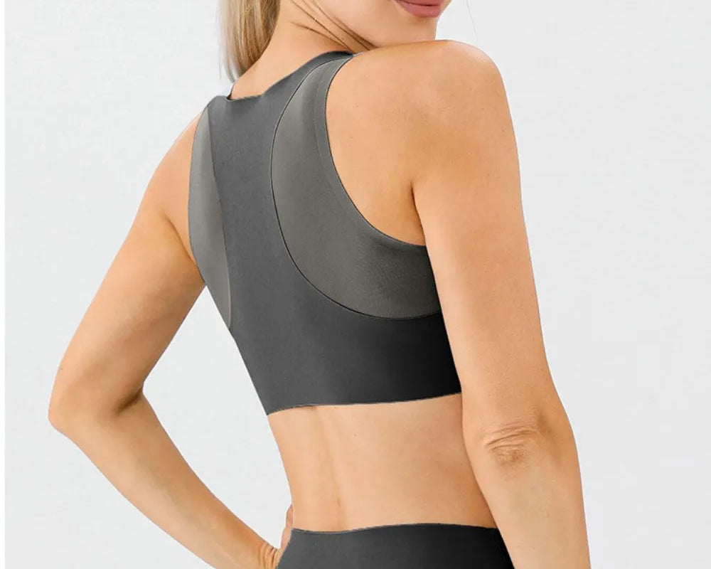 NEWYORKLISTED ACTIVEWEAR COLLECTION: Woman wearing a black sports bra and leggings on a light gray background