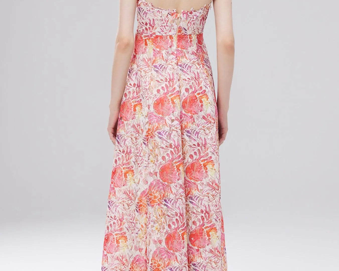 NEWYORKLISTED STYLE COLLECTION: Woman wearing a floral dress on a white background