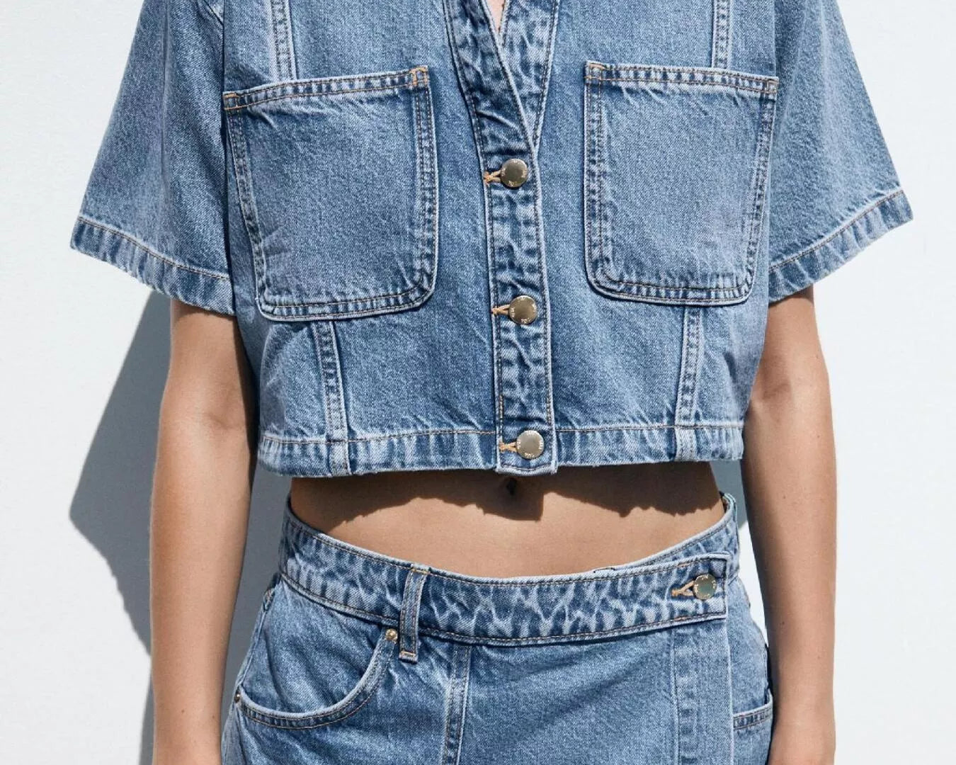 NEWYORKLISTED STYLE COLLECTION: Person wearing a denim jacket and skirt on a white background