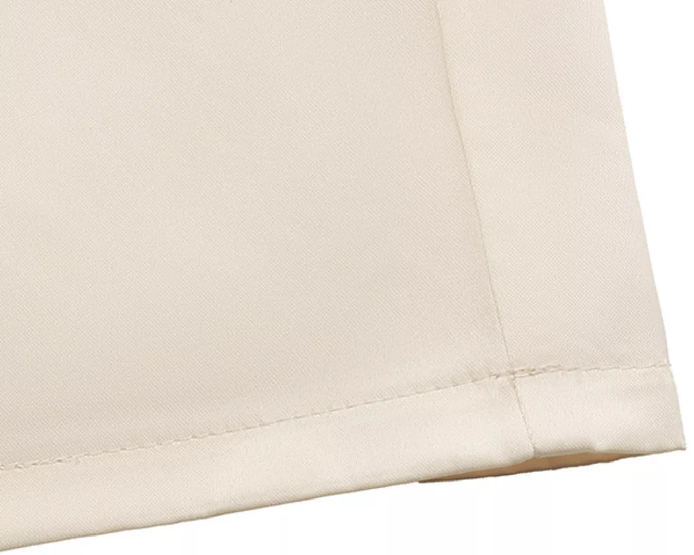 NEWYORKLISTED STYLE COLLECTION: Close-up of beige fabric with a subtle texture on a white background