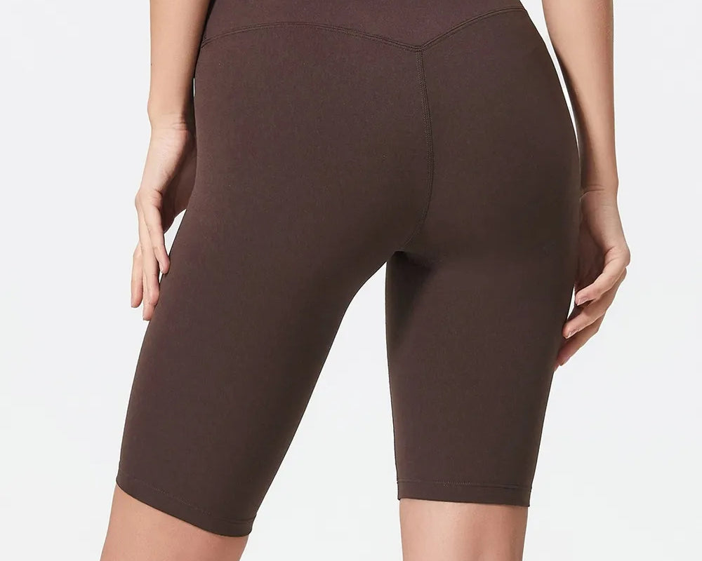 NEWYORKLISTED ACTIVEWEAR COLLECTION: Person wearing brown high-waisted shorts on a plain background