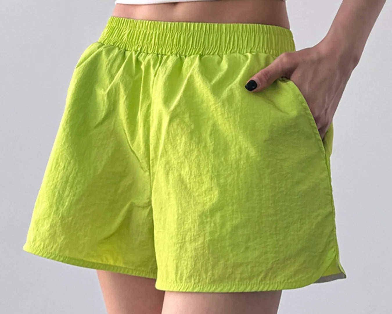 NEWYORKLISTED Activewear: Elastic Waist Active Shorts in bright green shorts on a plain background