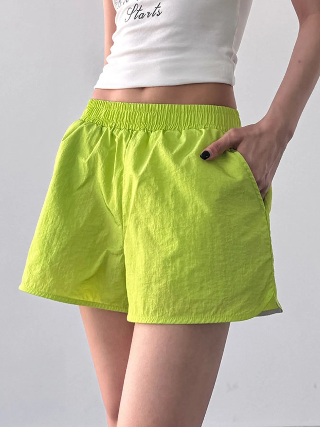 NEWYORKLISTED Activewear: Elastic Waist Active Shorts in bright green shorts on a plain background