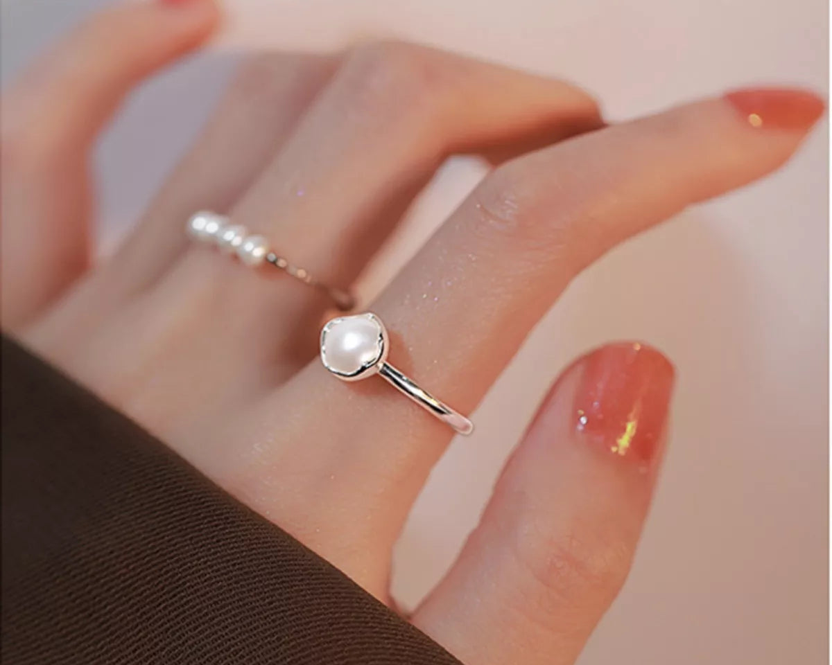 NYLD Glamour By NEWYORKLSITED: Sterling silver ring with a freshwater pearl on a hand with red nail polish