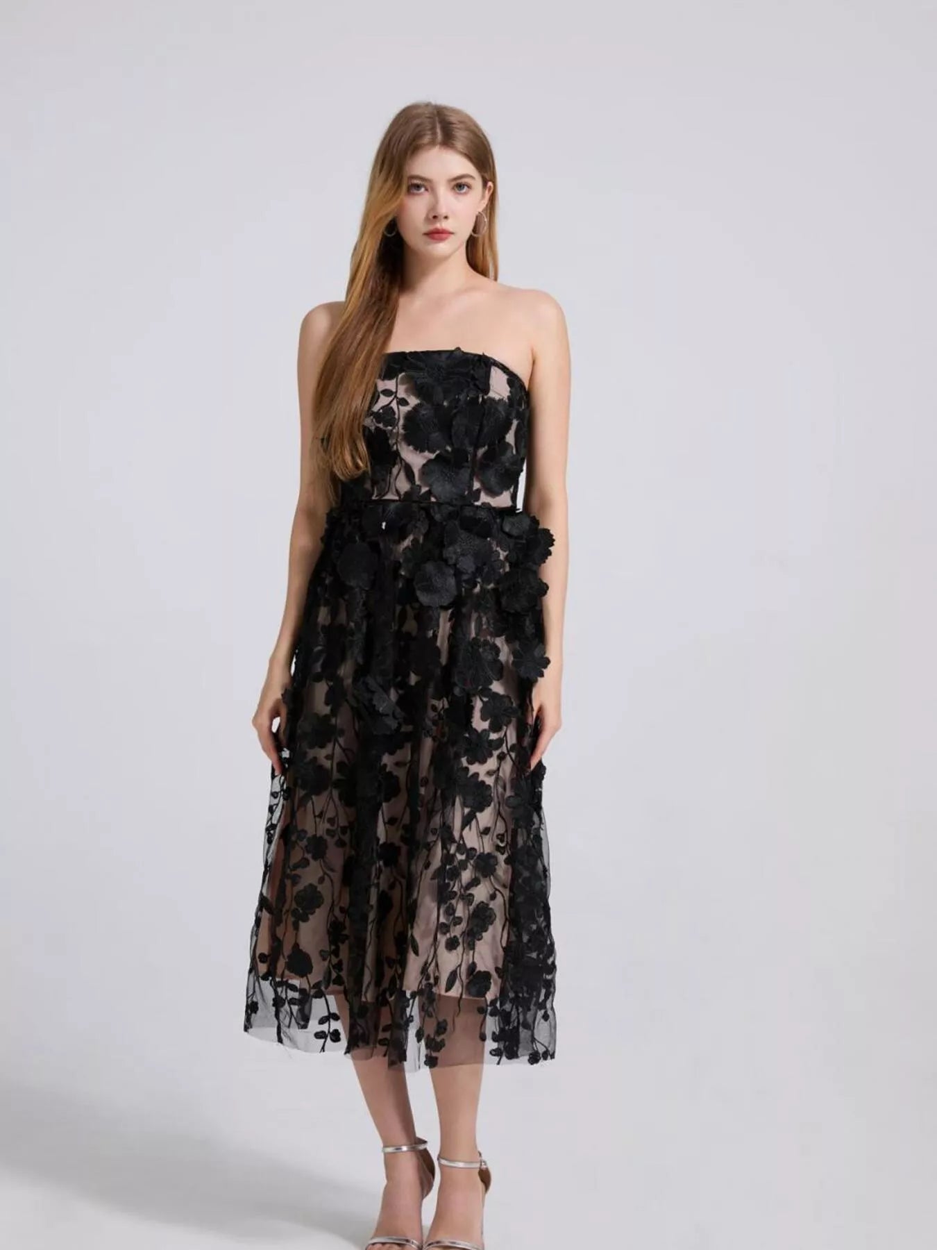 NEWYORKLISTED STYLE COLLECTION: Woman wearing a black floral dress on a white background