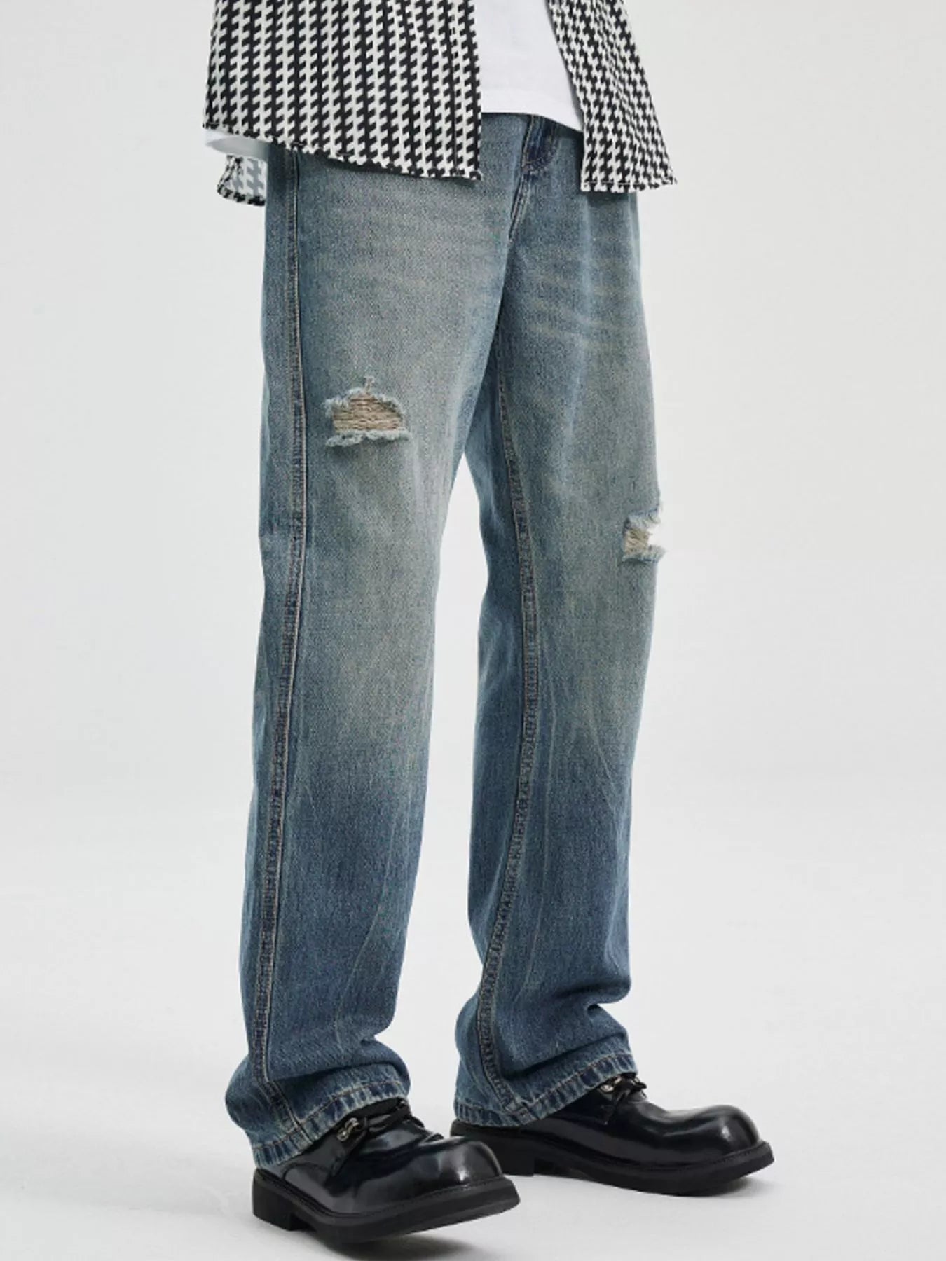 NEWYORKLISTED ATLAS MEN's COLLECTION: Person wearing distressed blue jeans and a checkered shirt on a white background