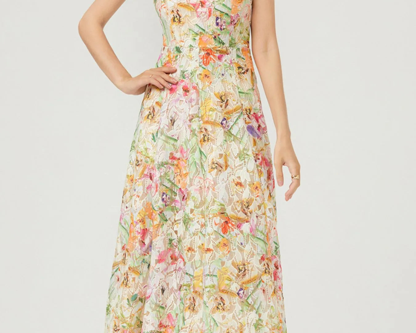 NEWYORKLISTED STYLE COLLECTION: Woman wearing a floral dress on a white background