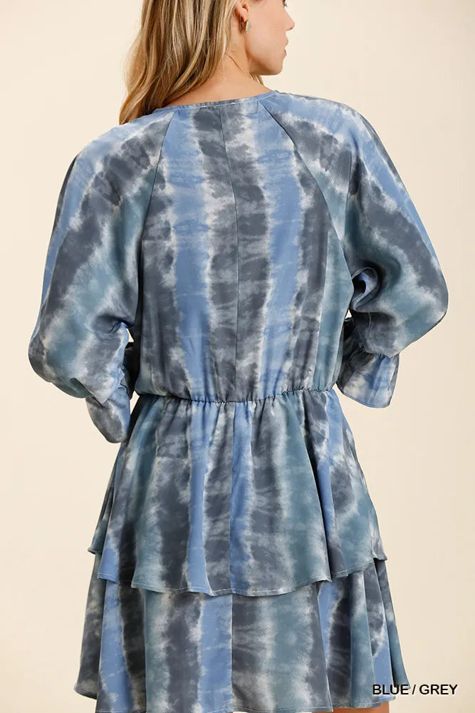 NEWYORKLISTED STYLE COLLECTION: Blue and gray tie-dye dress with puffed sleeves on a beige background