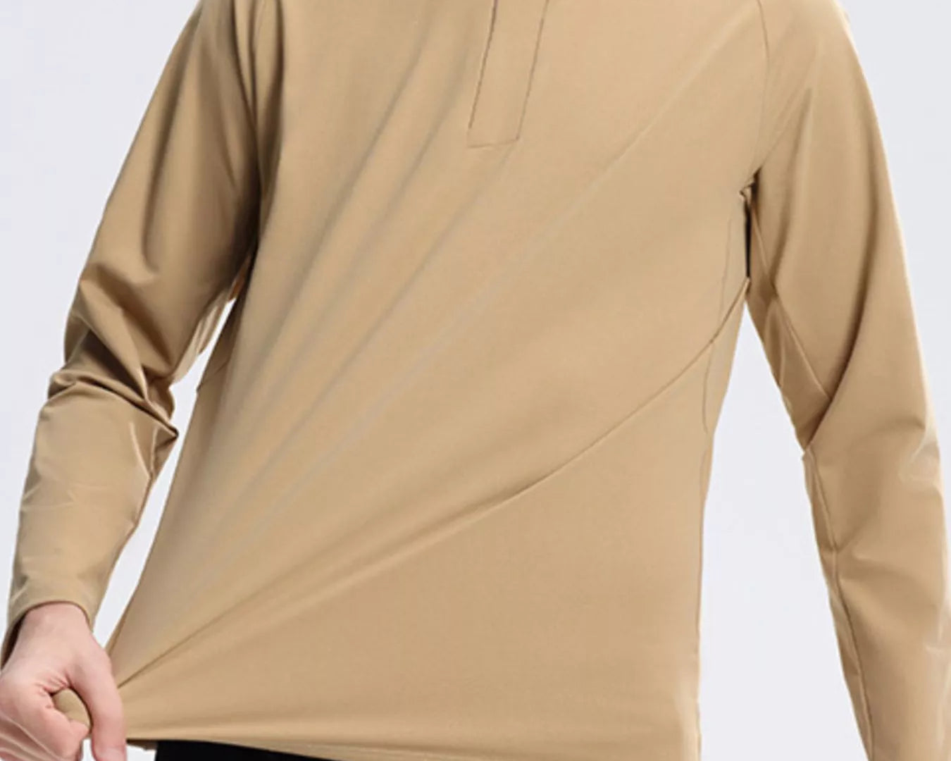 NEWYORKLISTED ATLAS MEN's COLLECTION: Man wearing a beige long-sleeve shirt on a light gray background