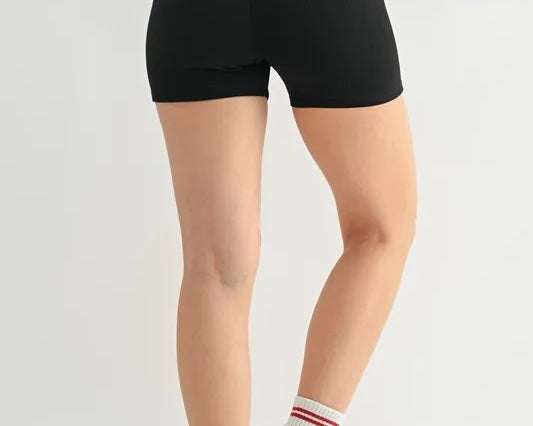 NEWYORKLISTED ACTIVEWEAR: Person wearing black high-waisted shorts on a plain background