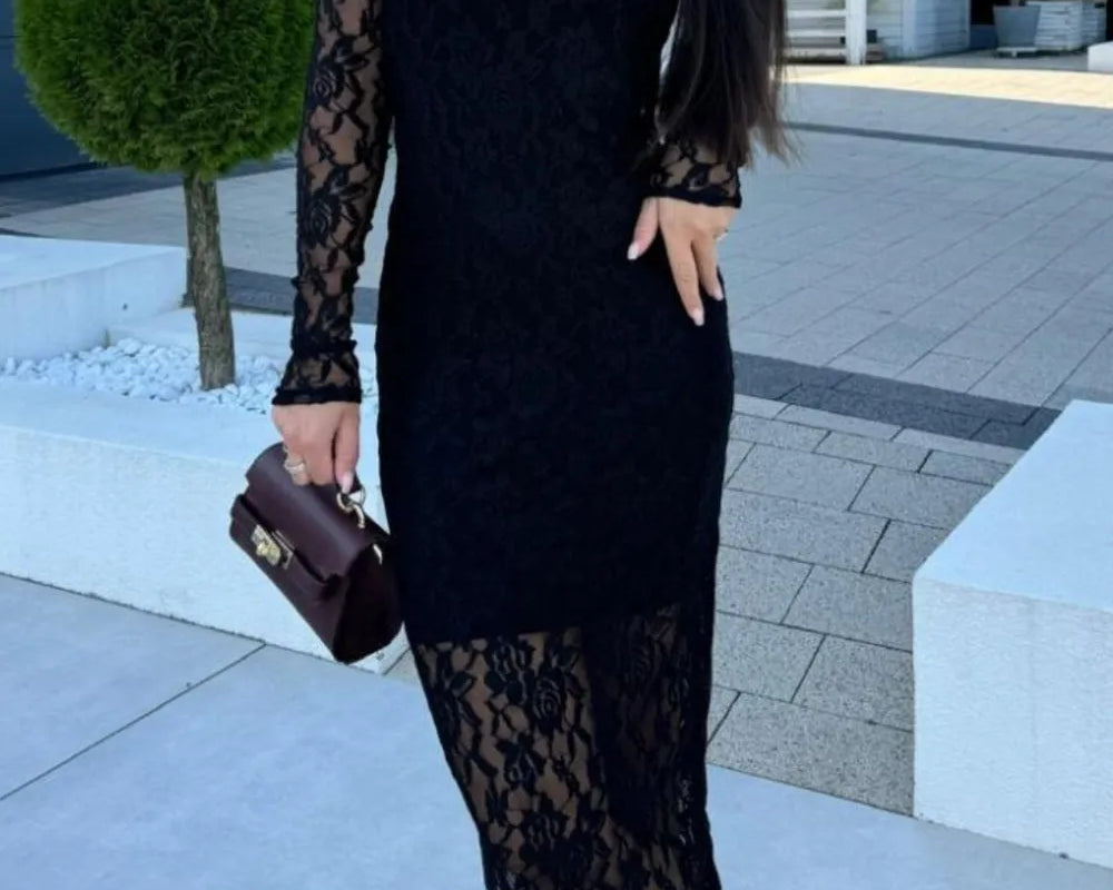 NEWYORKLISTED Valentine's Day Specials: Woman wearing a black lace dress standing outdoors on a paved area.