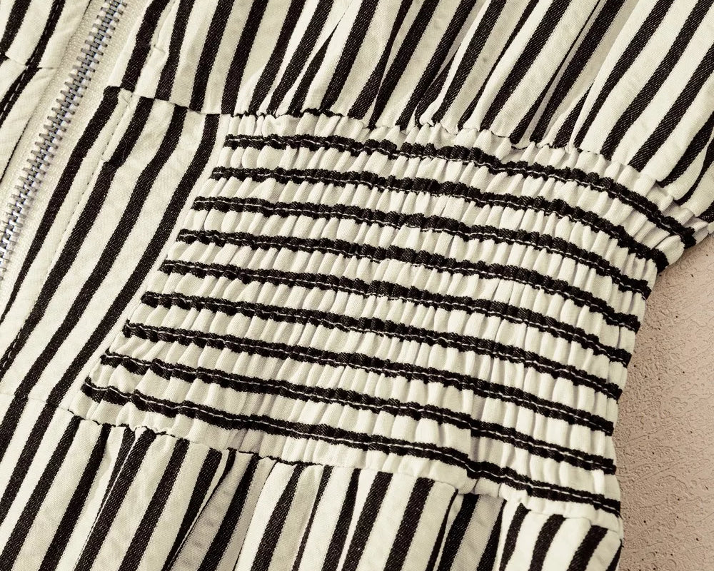 NEWYORKLISTED STYLE COLLECTION: Close-up of a black and white striped garment with a textured pattern.