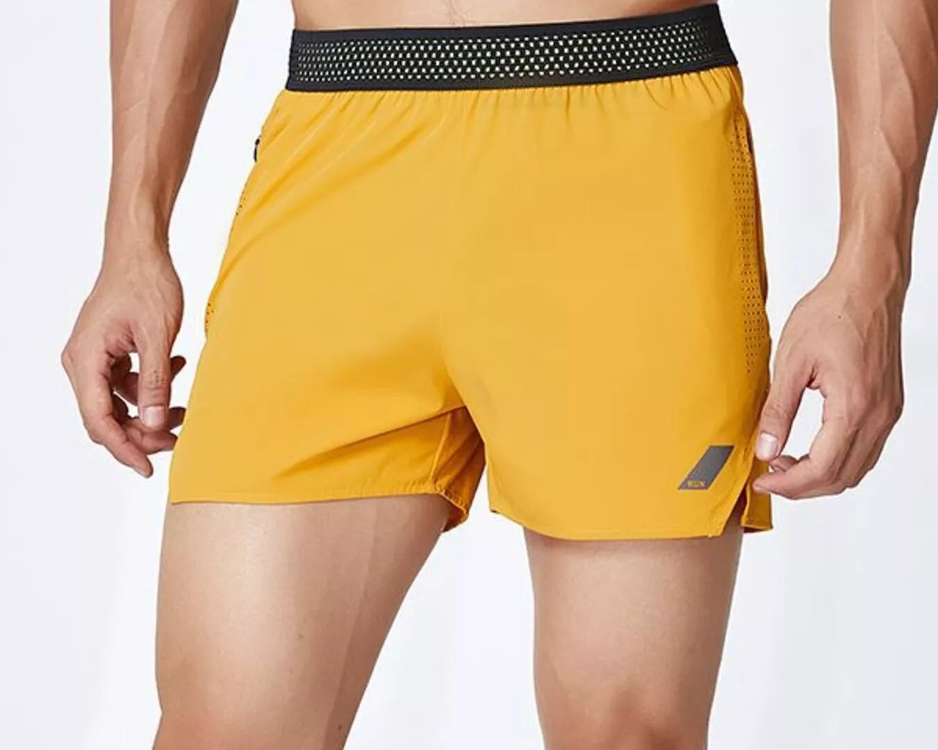 NEWYORKLISTED ATLAS MEN's COLLECTION: Yellow athletic shorts with a black waistband on a white background