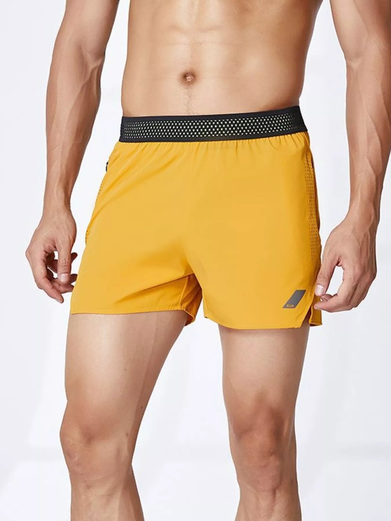 NEWYORKLISTED ATLAS MEN's COLLECTION: Yellow athletic shorts with a black waistband on a white background