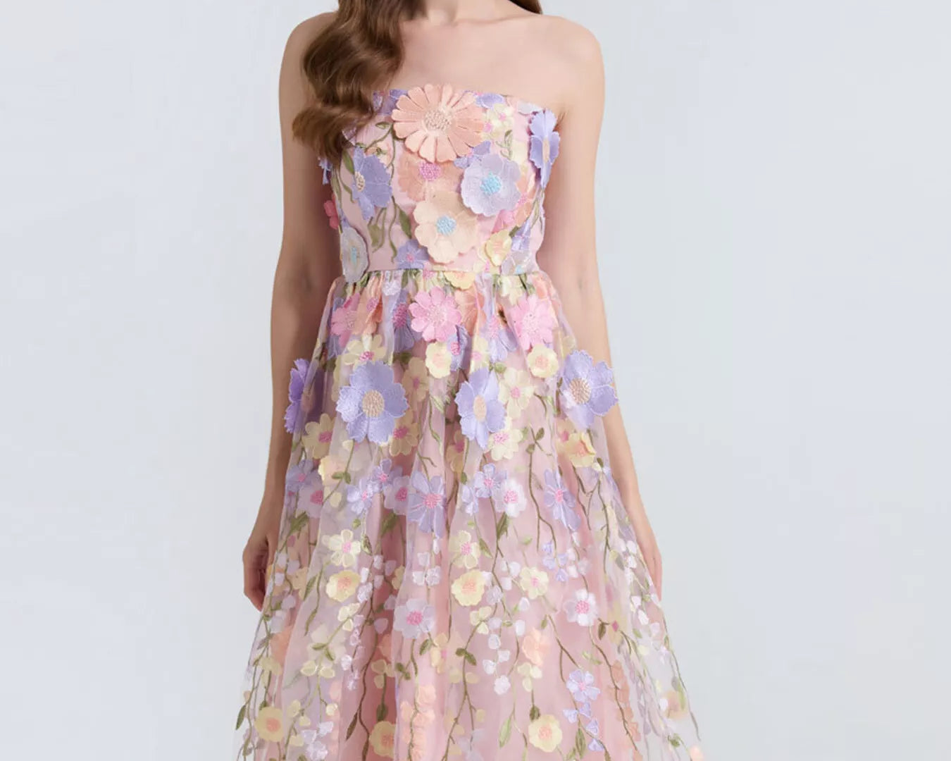 NEWYORKLISTED STYLE COLLECTION: Woman wearing a floral dress on a white background