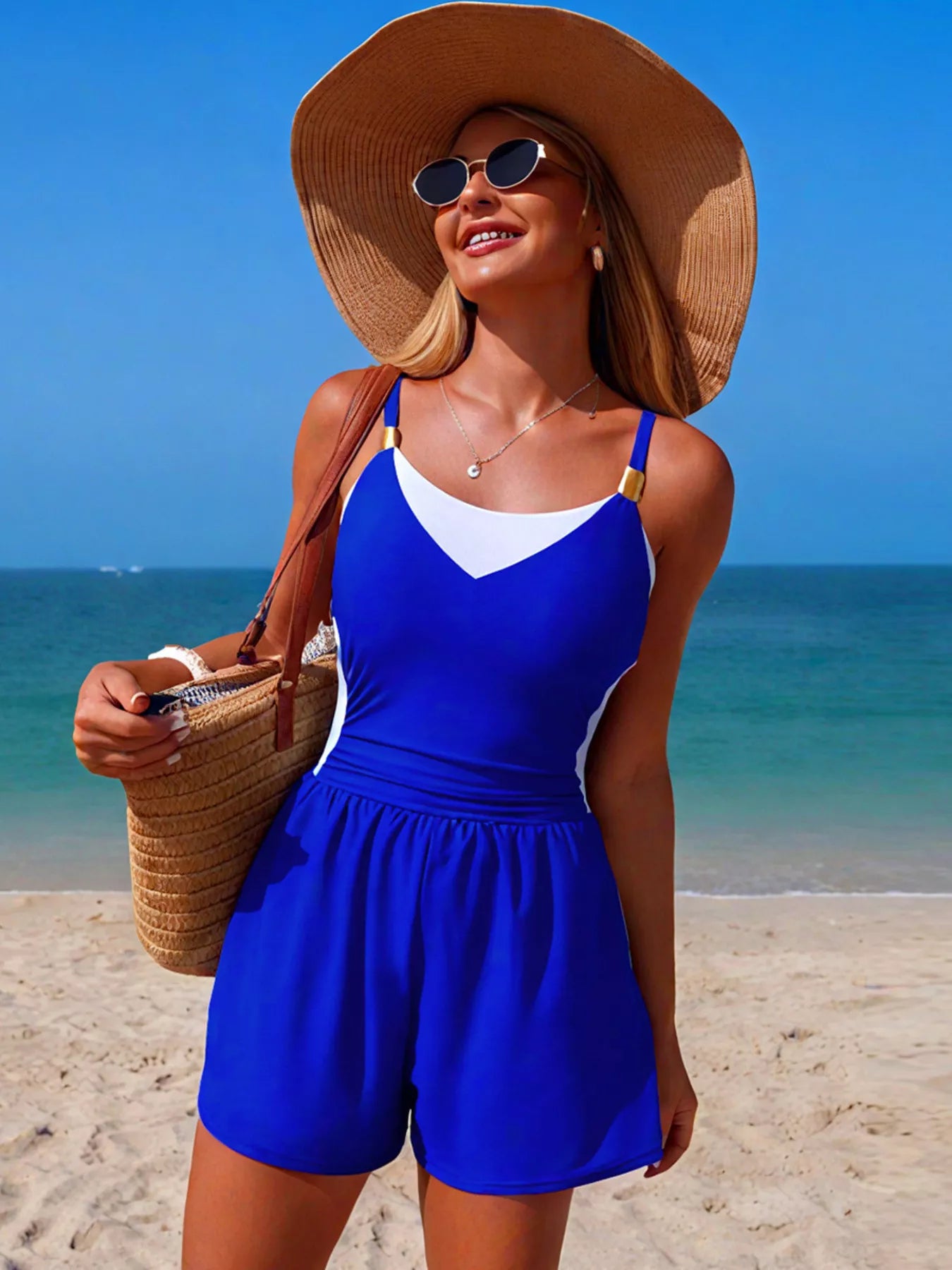 NEWYORKLISTED EDEN COLLECTION: Woman in a blue swimsuit and sun hat on a beach