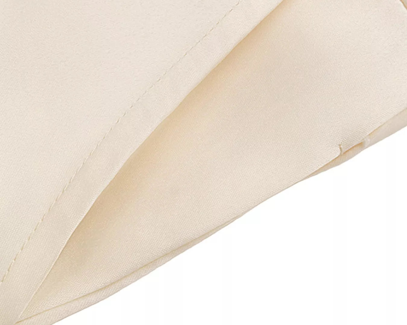Close-up of a beige quilted fabric corner on a white background