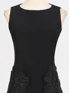 NEWYORKLISTED STYLE COLLECTION: Black sleeveless dress with floral appliqués on a mannequin against a white background