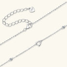 NEWYORKLISTED Valentine’s Day Specials: Two silver anklets with heart-shaped charms on a white background