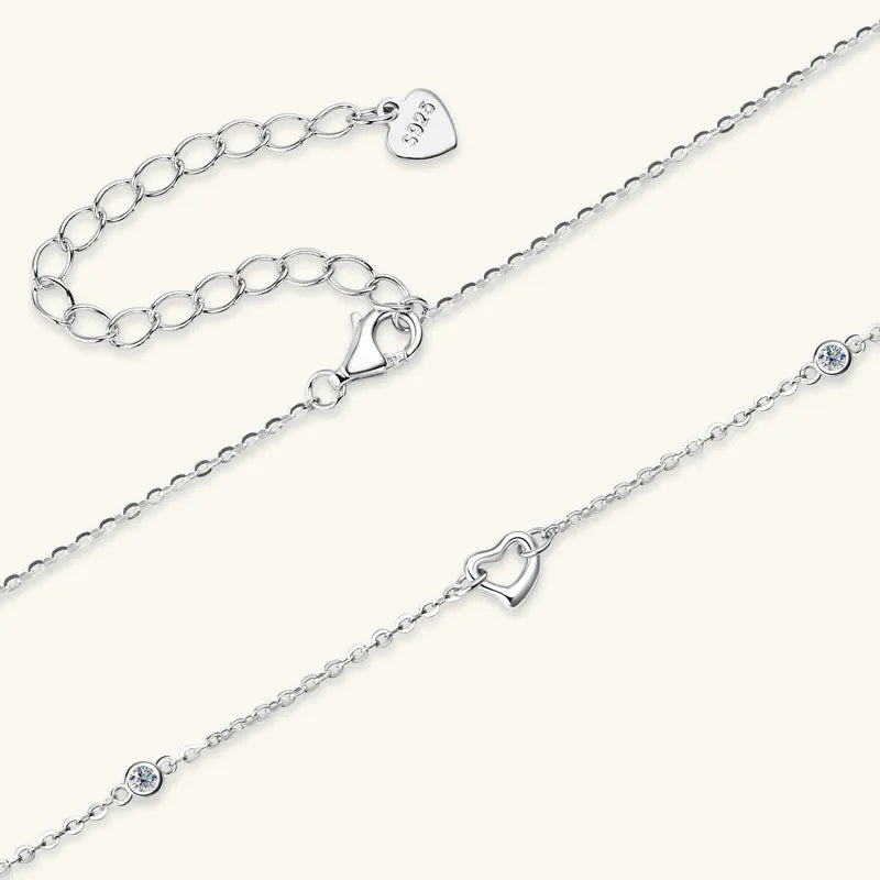 NEWYORKLISTED Valentine’s Day Specials: Two silver anklets with heart-shaped charms on a white background