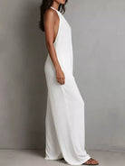 NEWYORKLISTED STYLE COLLECTION: Woman wearing a white sleeveless dress against a gray background