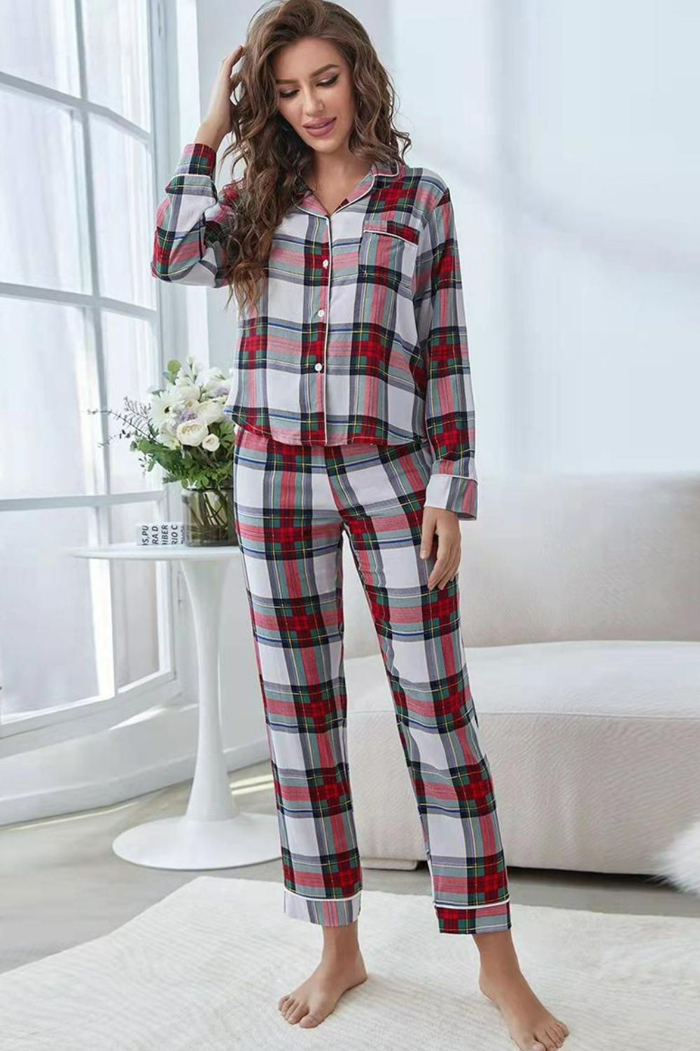 NEWYORKLISTED Intimate Apparel: Woman wearing a plaid pajama set in a bright room with white curtains and a white couch.