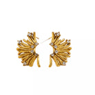 NYLD Glamour Collection by NEWYORKLISTED: Gold leaf-shaped earrings with embedded stones on a white background