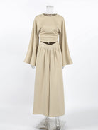 NEWYORKLISTED STYLE COLLECTION: Beige long-sleeve top and skirt set on a mannequin against a white background
