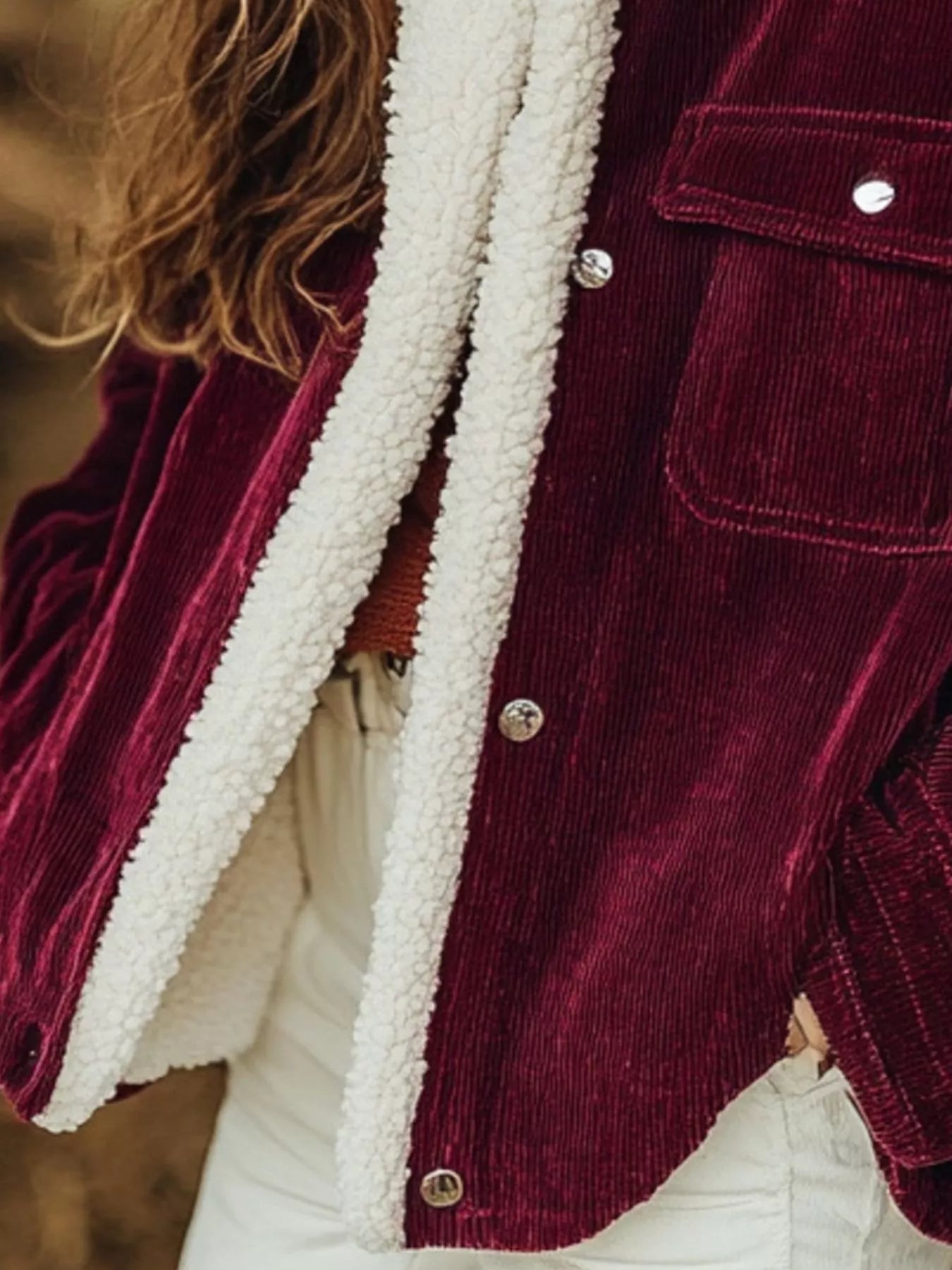 NEWYORKLISTED STYLE COLLECTION: Close-up of a burgundy corduroy jacket with white fleece lining.