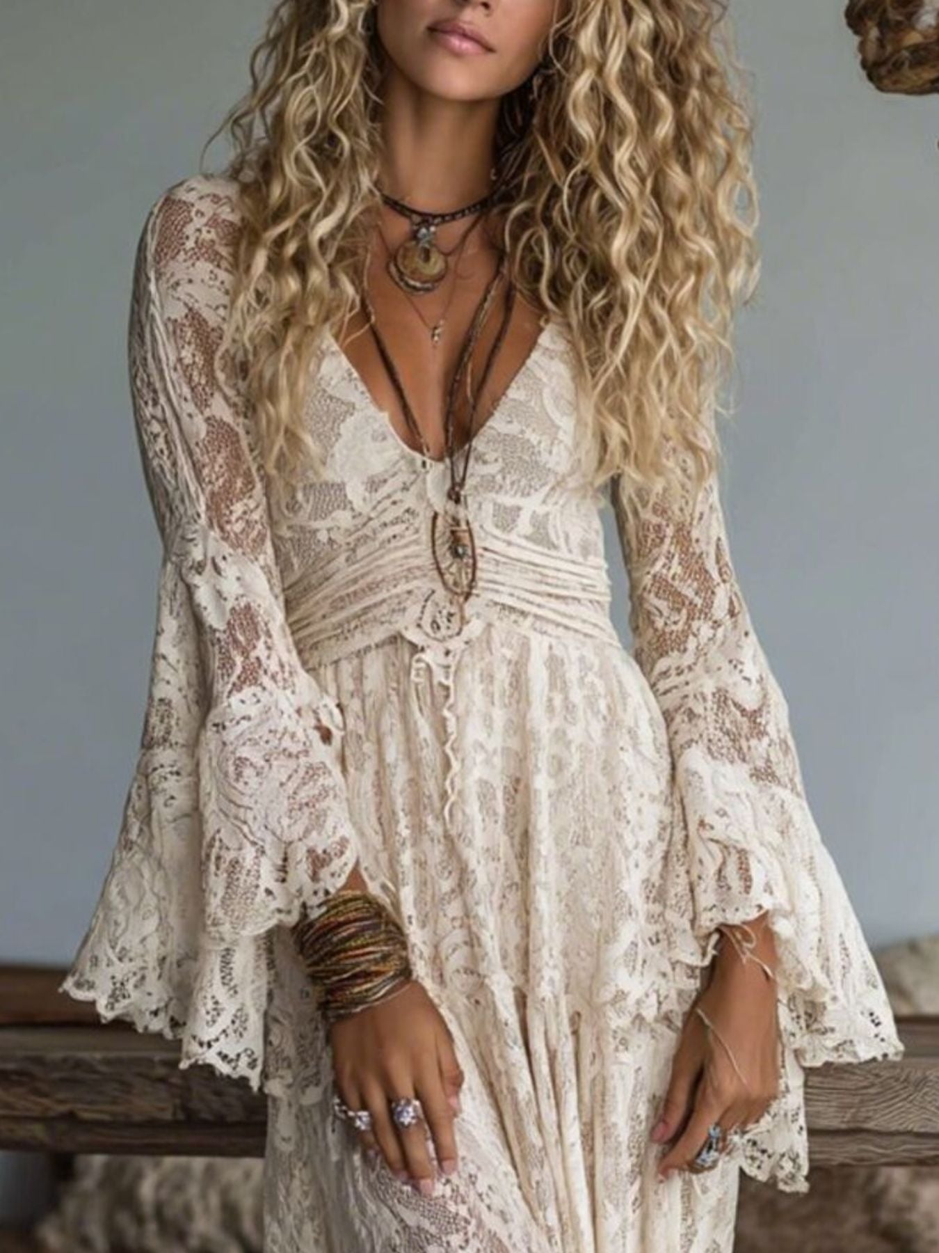 NEWYORKLISTED STYLE COLLECTION: Woman wearing a lace dress with long sleeves and layered necklaces.