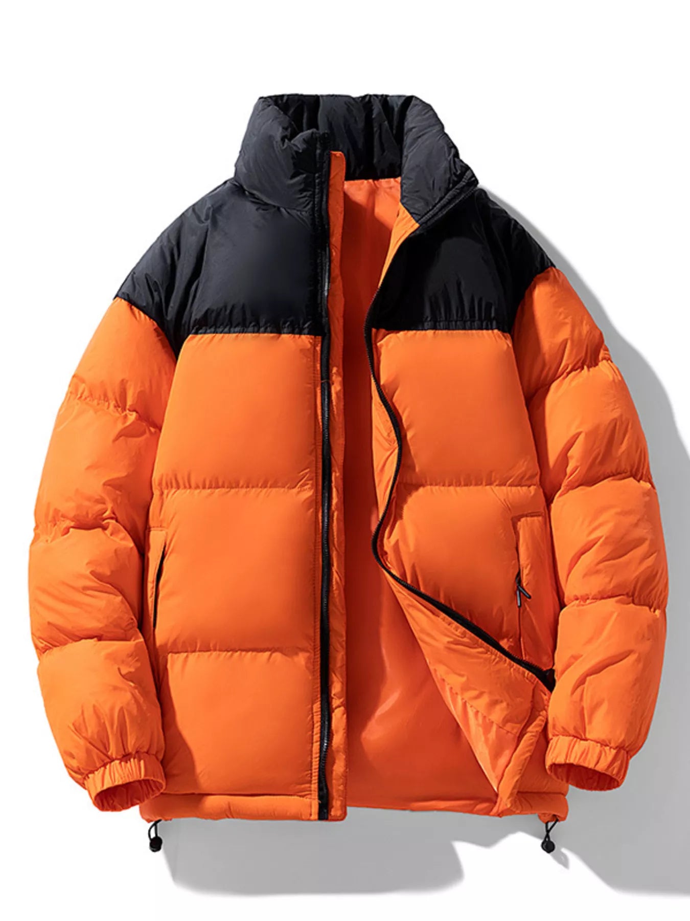 NEWYORKLISTED ATLAS MEN’S COLLECTION: Orange puffer jacket with black accents on a white background