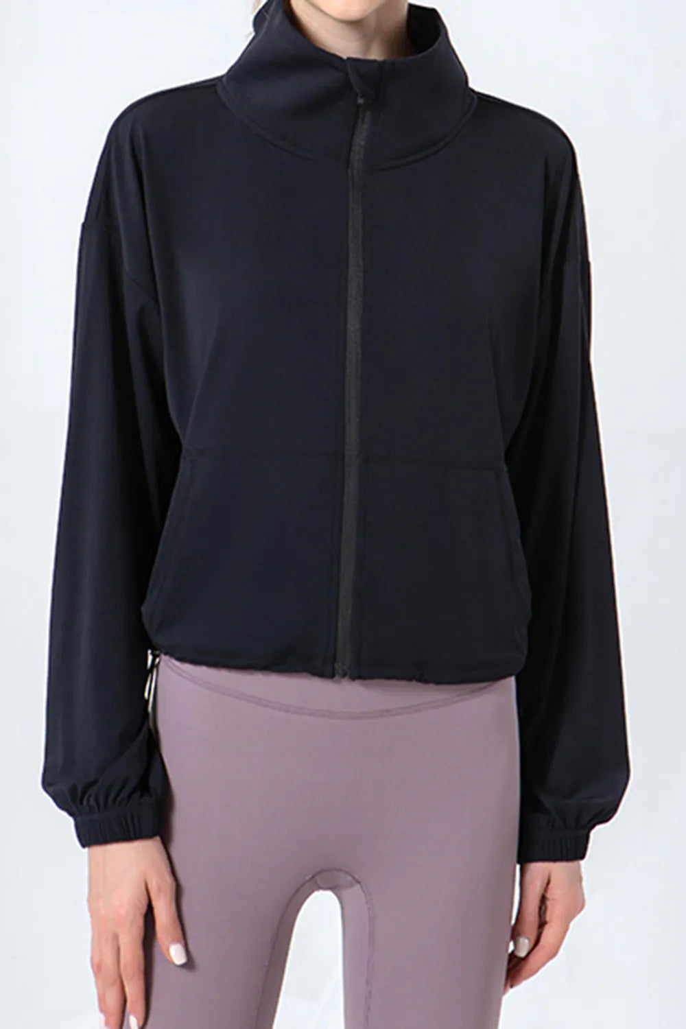 NEWYORKLISTED ACTIVEWEAR COLLECTION: Black jacket and gray leggings on a white background