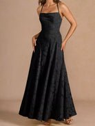 NEWYORKLISTED STYLE COLLECTION: Black evening gown on a beige background