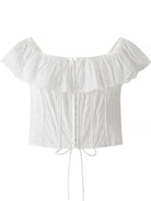 NEWYORKLISTED STYLE COLLECTION: White off-shoulder top with ruffled details on a white background