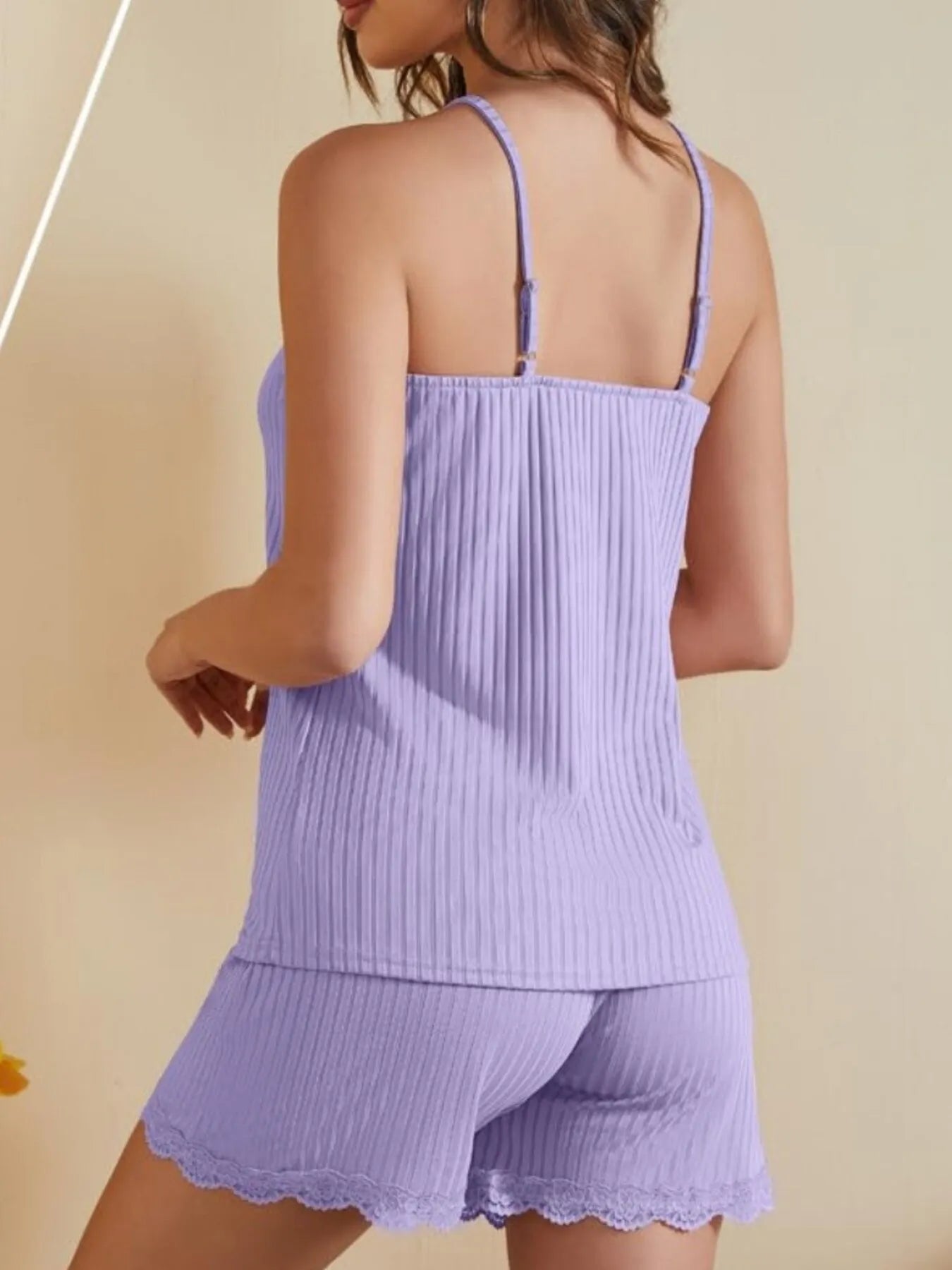 NEWYORKLISTED Intimate Apparel: Light purple ribbed romper with lace trim on a beige background