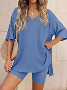 Woman wearing a blue outfit with a plain background