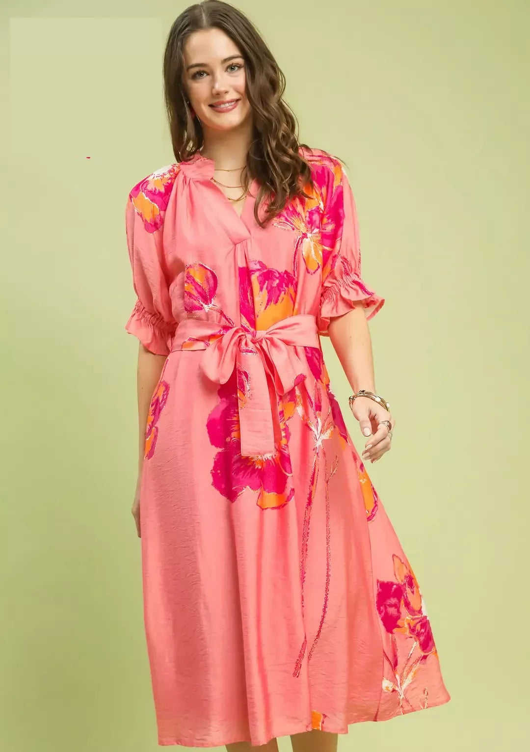 NEWYORKLISTED STYLE COLLECTION: Woman wearing a pink floral dress on a light green background