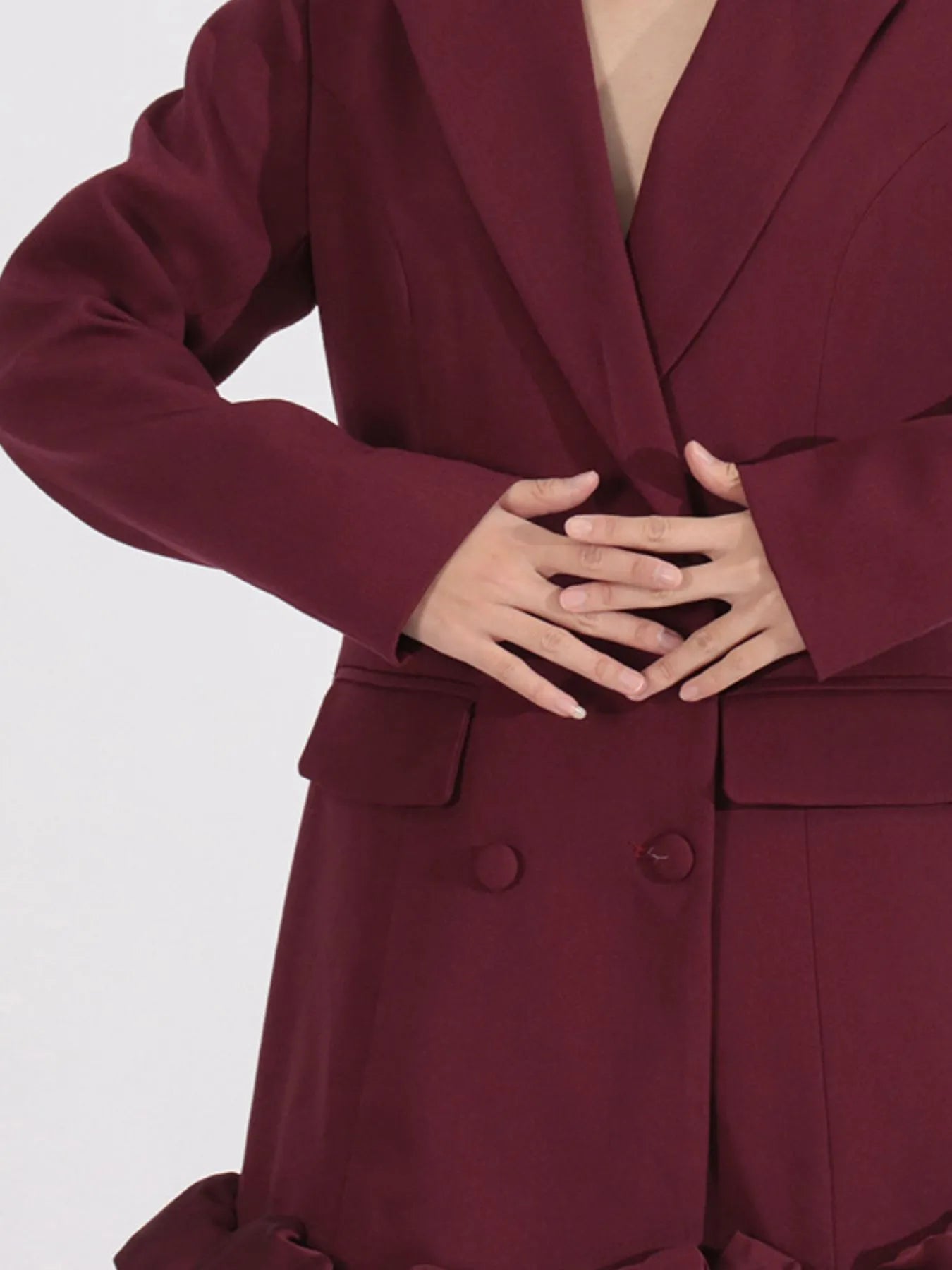 NEWYORKLISTED Runway Style: Maroon coat worn by a person on a white background