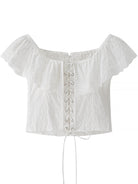 NEWYORKLISTED STYLE COLLECTION: White off-shoulder top with lace-up front on a white background
