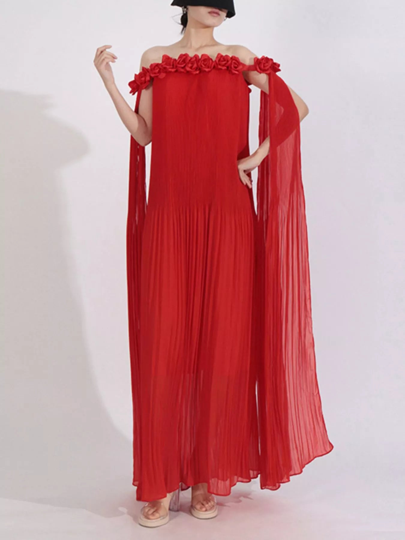 NEWYORKLISTED STYLE COLLECTION:  Red off-shoulder dress with floral details on a white background