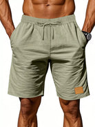 NEWYORKLISTED ATLAS MEN'S COLLECTION: Green shorts with a drawstring on a white background