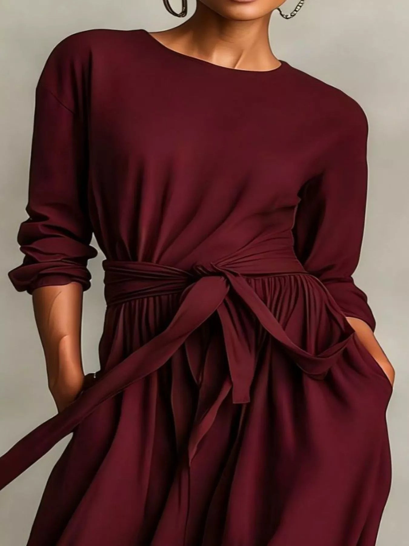 NEWYORKLISTED STYLE COLLECTION: Maroon dress with a tie waist worn by a person on a neutral background