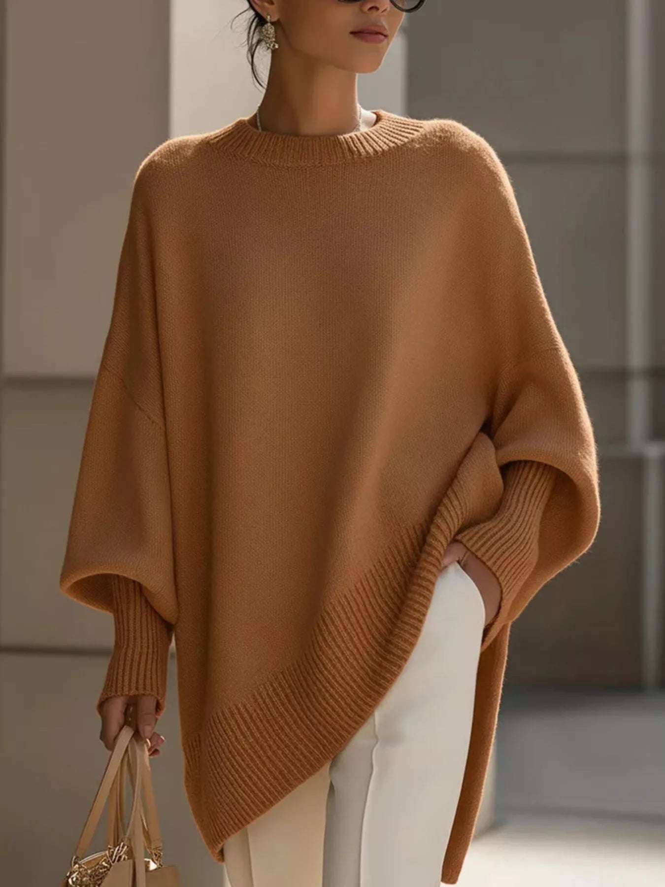 NEWYORKLISTED STYLE COLLECTION: Person wearing a brown poncho with a blurred background